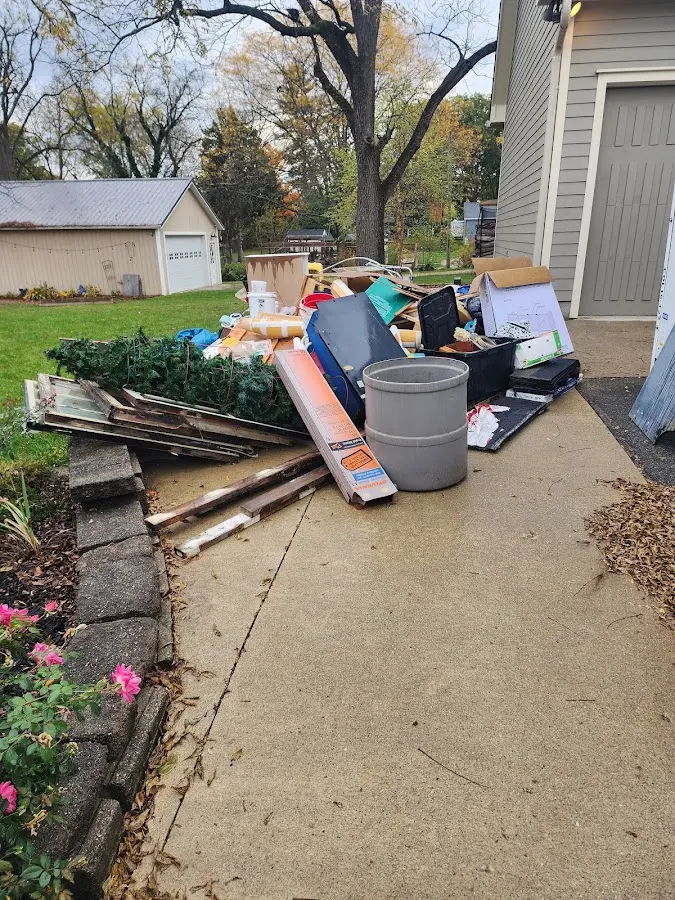 Dumpster being loaded with debris for Estate Cleanout Dumpster Rental in Brillion